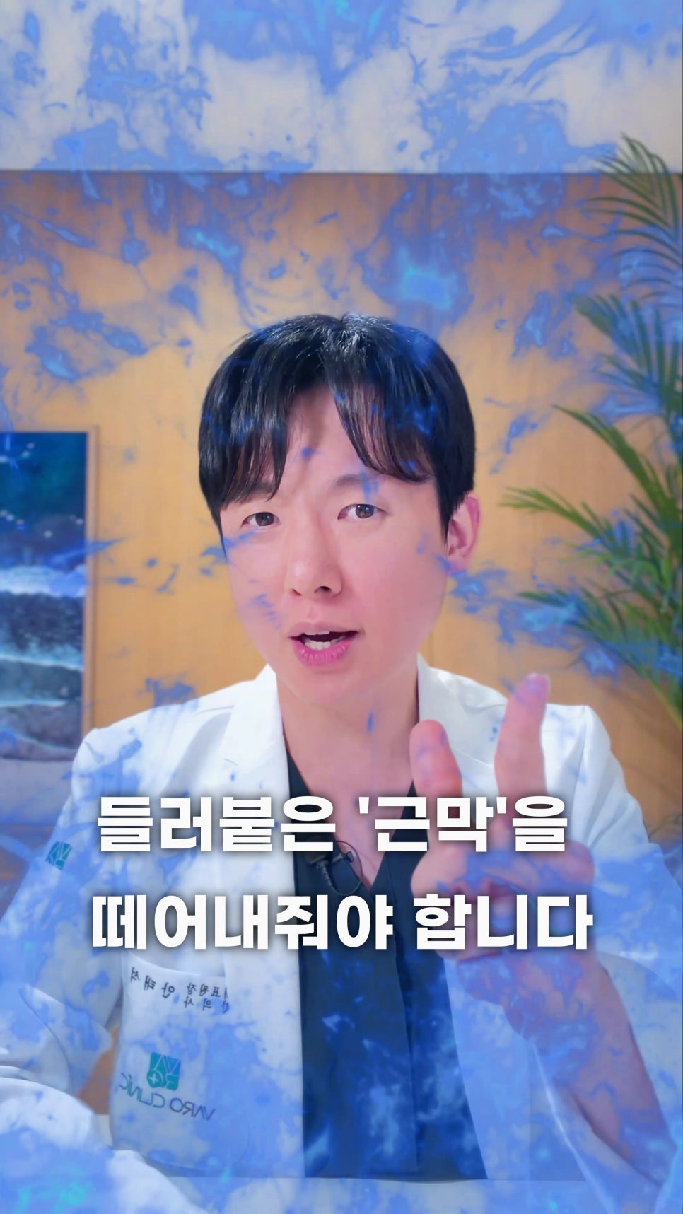 흰색 가운을 입은 남성이 정면을 보며 손가락으로 가리키고 있으며, '들러붙은 근막을 떼어내줘야 합니다'라는 문구가 적혀 있습니다.