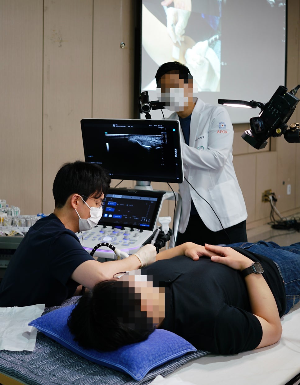 한의사가 환자의 목 부위에 초음파 기기를 대고 시술하는 모습과 초음파 화면.